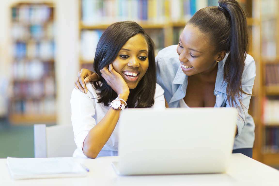 african college students using laptop together